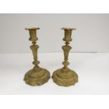 A pair of cast brass candlesticks in the 19th Century French taste.