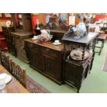 A Victorian carved oak serving cabinet the raised shelf back with green man decoration to drawers