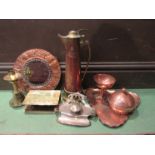 An assortment of early copper and brass wares including Art Nouveau jug dishes and wall mirror