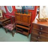 In the Manner of 'Liberty & Co' a walnut writing cabinet with gilt ormolu winged mounts the drop