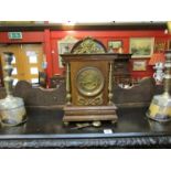 A Circa 1900 mantel clock striking on a coiled gong mahogany case with pineapple finial detail