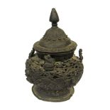 A Tibetan bronze censer, finial top with pierced foliate border,