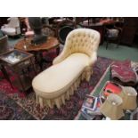 A Victorian faux rosewood daybed/sofa the button-back rest over carved cabriole legs and brass cup