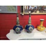 A pair of Royal Doulton vases, bulbous blue ground body with tapering neck to flared rim.