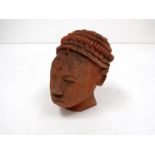 An African terracotta sculpture of a female head,