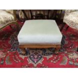 A Victorian mahogany footstool the sage upholstered seat over claw on ball cabriole feet and shaped