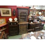 A late Victorian heavily carved oak floor-standing display cabinet in the Bavarian Baronial style