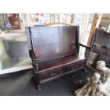An 18th Century and later oak box seat hall settle with carved decoration and hinged seat over