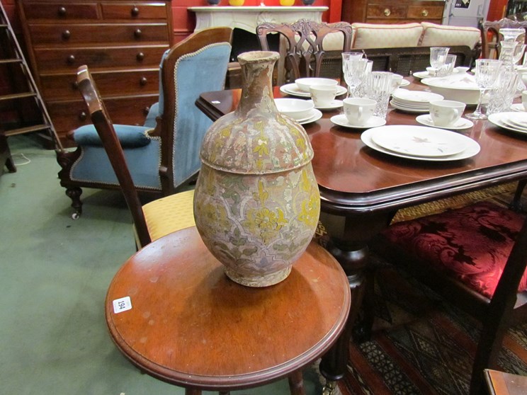 An antique hand thrown terracotta pouring vase of baluster form with narrow cylindrical neck,