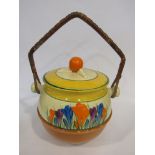 A Clarice Cliff Newport Pottery crocus pattern biscuit jar with wicker swing handle