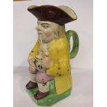 A late 18th / early 19th Century Staffordshire Toby jug, yellow jacket, smoking a pipe,