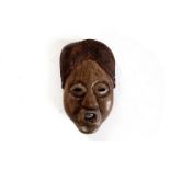 A carved heavy native wood tribal wall mask,