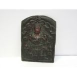 An INDIAN repoussé bronze plaque decorated with a deity and symbols of life, prosperity and family,