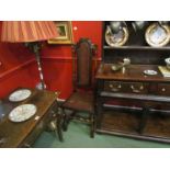 A pair of 17th Century style walnut bergere chairs with carved relief and turned supports