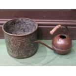 A bygone copper watering can and a brass planter