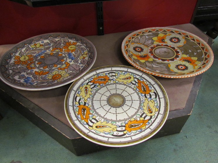 Three Charlotte Rhead by Crown Ducal pottery chargers, floral and foliate design,
