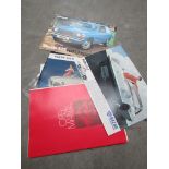 A quantity of mixed brochures including Mazda 110s opel, Volvo 122s,