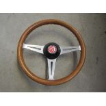 A stainless steel and wooden rimmed steering wheel - MG