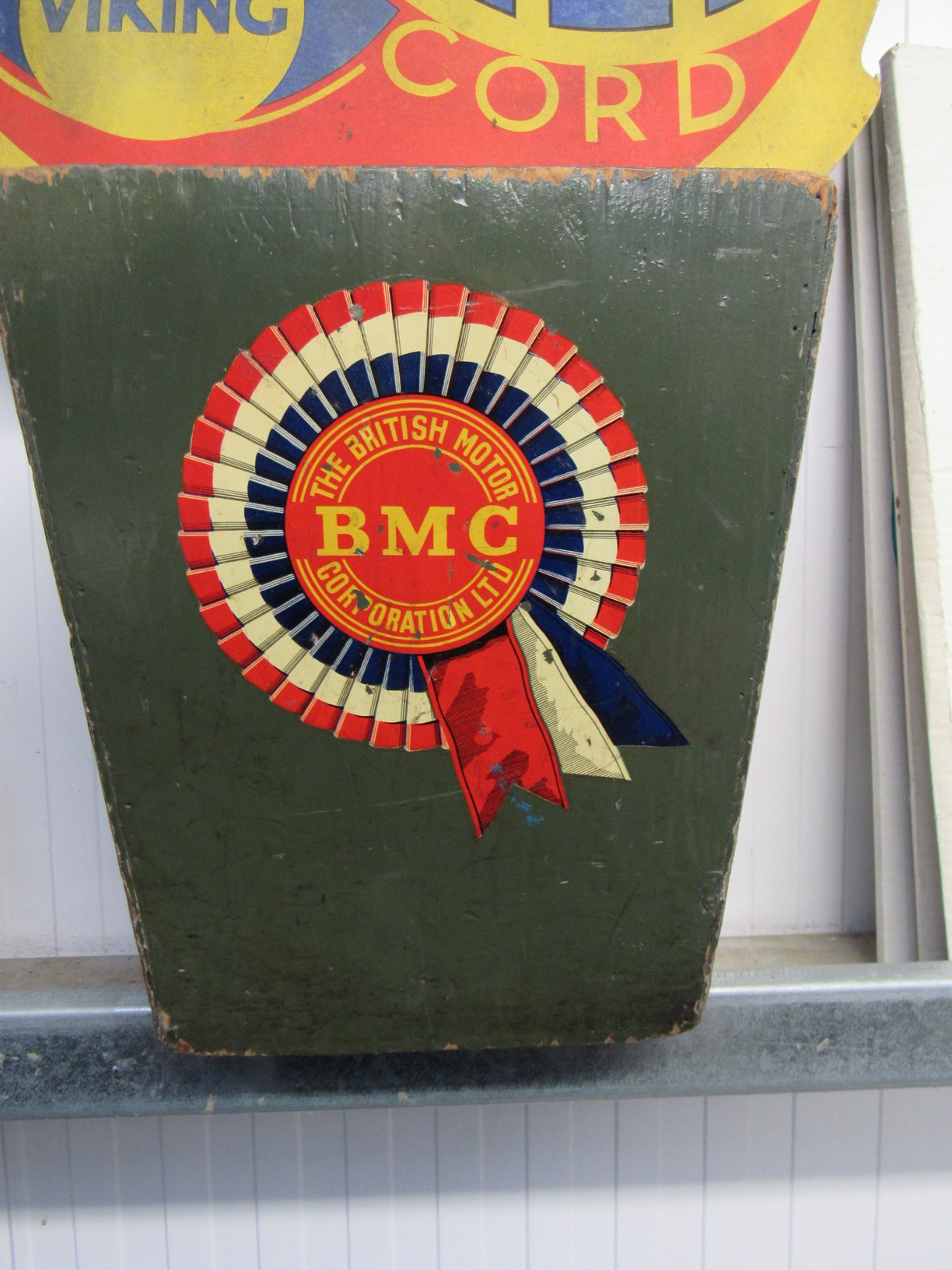 A cardboard Palmer Viking cord sign and a BMC bin