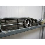A Mercedes front grille and a set of four hubcaps