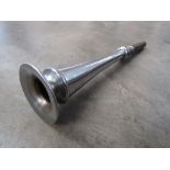 A chromed trumpet horn stamped to rim