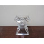 A crystal glass candle stand of stepped square form,