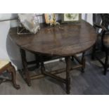 An 18th Century oak drop-leaf dining table with single drawer