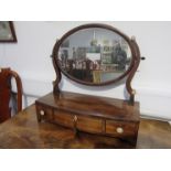 A Georgian oval table top mirror with jewellery drawers