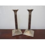 A pair of Walker and Hall silver plate Corinthian column candlesticks,