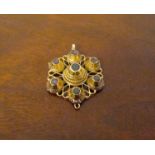 A gold garnet set pendant,