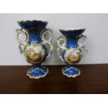 A pair of 19th Century Coalport style vases with landscape cartouches,