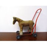A vintage childs walker of horse form