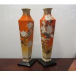 A pair of 19th Century Oriental orange and hand painted rhombus form vases with wooden bases,