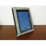 A velvet and pierced metal easel back photograph frame,