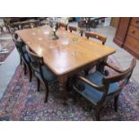 A Victorian mahogany dining table on melon fluted legs to brass castors.