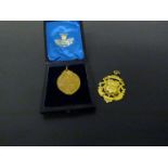 A 9ct gold medallion and another unmarked