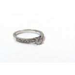 A 9ct white gold ring single diamond with diamond set shoulders