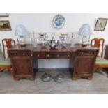 A Regency mahogany breakfront sideboard with brass gallery rail, one finial loose, veneer missing,