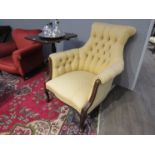 A button back chair in gold upholstery