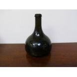 An 18th Century glass onion bottle