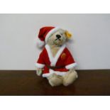 A Steiff Teddy bear in santa outfit,
