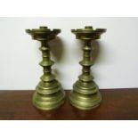 A pair of Pugin designed brass ecclesiastical candlesticks, castellated tops,