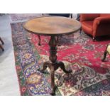 A Victorian mahogany tripod wine table with turned stem.