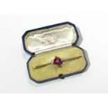 A gold diamond and synthetic ruby bar brooch,