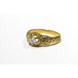 A 19th Century diamond solitaire ring with ornate engraved shank approx .