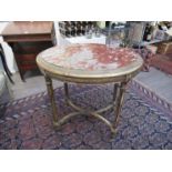 An 18th Century French gilt wood oval table, he top inset with marble panel.