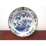 An 18th Century tin glazed Oriental charger, fence and tree pattern,