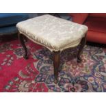 A 19th Century serpentine stool with cabriole legs,