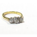 An 18ct gold platinum set three stone diamond ring the central round cut diamond .