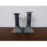 A pair of silver candlesticks with beaded detail,